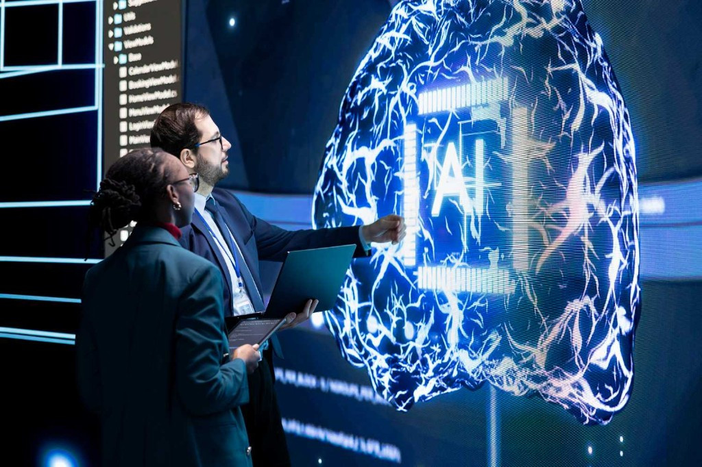 AI infrastructure team in front of large neural network screen