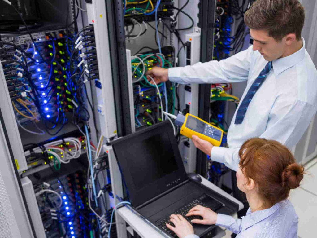 Technicians testing cabling during a data centre installation